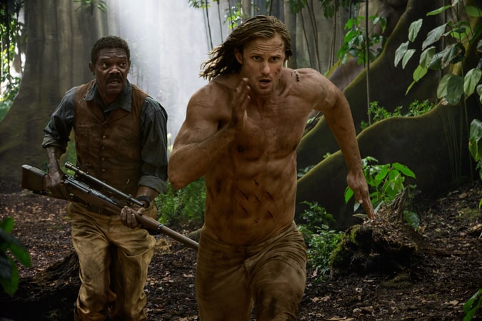 SAMUEL L. JACKSON as George Washington Williams and ALEXANDAR SKARSGÅRD as Tarzan run through the jungle