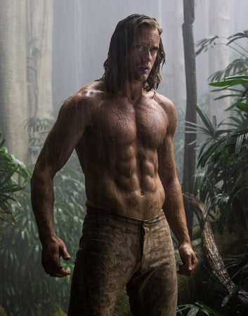 Shirtless Alexander Skarsgård as Tarzan standing in the rain