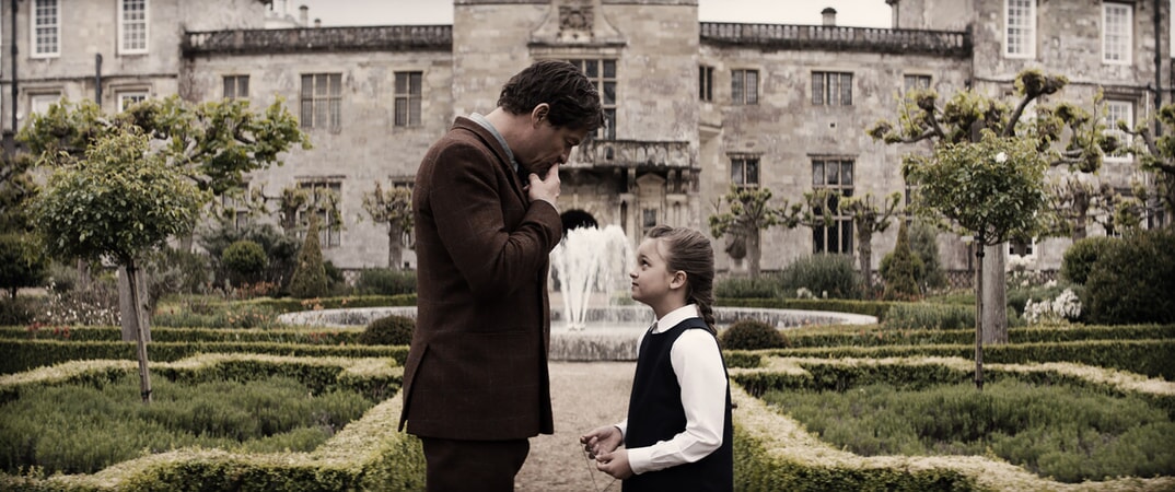 (L-R) DOMINIC WEST as Richard Croft and MAISY DE FREITAS as Young Lara (7 years old) in Warner Bros. Pictures' and Metro-Goldwyn-Mayer Pictures' action adventure "TOMB RAIDER," a Warner Bros. Pictures release.