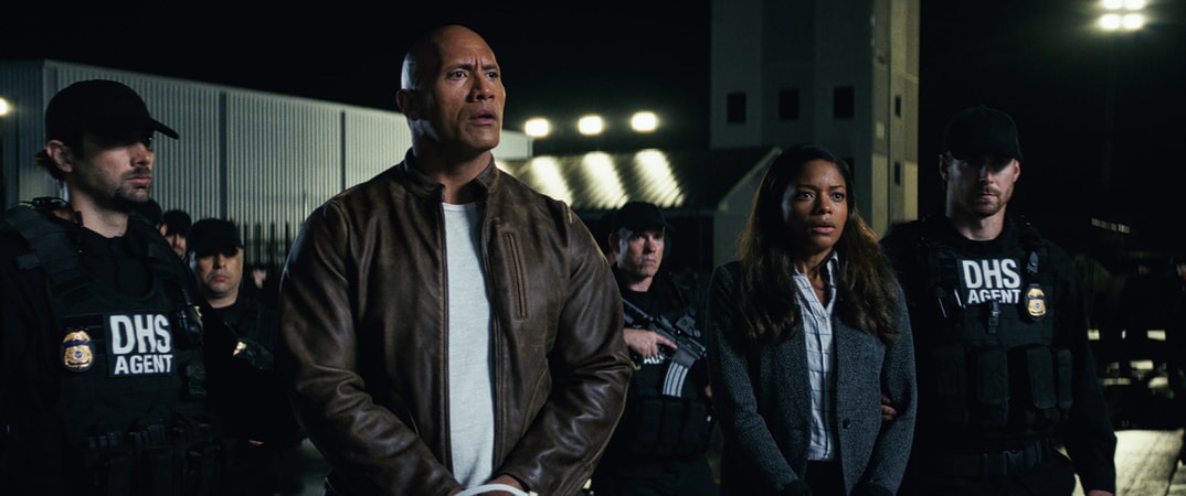 (Center L-R) DWAYNE JOHNSON as Davis Okoye and NAOMIE HARRIS as Dr. Kate Caldwell in New Line Cinema's and ASAP Entertainment's action adventure "RAMPAGE," a Warner Bros. Pictures release.